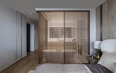 a bed sitting in a bedroom next to a wooden slatted wall on top of a hard wood floor