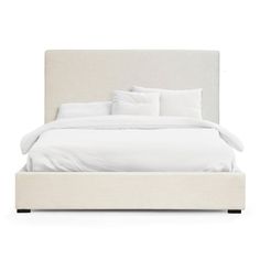 a bed with white linens and pillows on it's headboard, in front of a white background