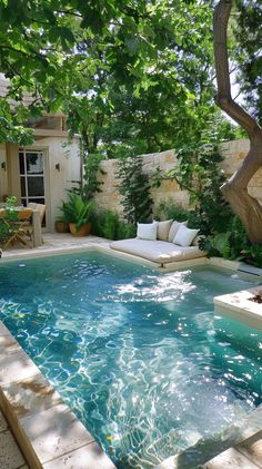 an outdoor swimming pool surrounded by greenery