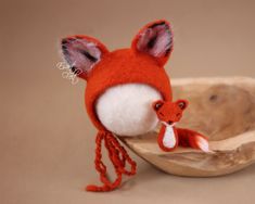 a small stuffed animal is sitting in a bowl