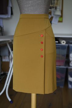 pencil side buttoned skirt with pocket on the left side handmade the skirt on the photo: color: camel buttons: vintage red round buttons (1 set available) fabric: stretchy (viscose & elastane mix) size: S (W:72-H:95-L:60)    available: in different colors: camel, red, vintage blue, black, green with different buttons: other options available (send me a request and we can mix and match) and other sizes:  36 (Waist: 72 - Hip: 95 - Length: 60) 38 (W: 76 - H: 99 - L: 60) 40 (W: 80 - H: 103 - L: 60) Vintage Brown Skirt With Buttons, Retro Brown Bottoms With Buttons, Fitted Pencil Skirt With Buttons, Classic Pencil Skirt With Buttons, Retro Fitted Skirt With Pockets, Fitted Red Skirt With Buttons, Fitted Red Skirt With Button Closure, Red Fitted Skirt With Buttons, Retro Brown Skirt For Workwear