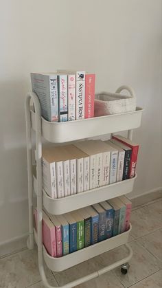 a book shelf with books on it and a towel rack in the corner behind it