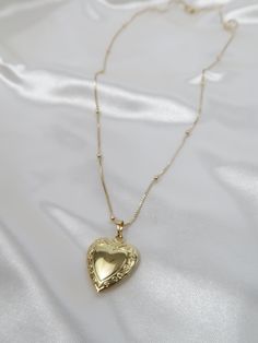 Vintage meets dainty. This heart locket is pure perfection! Add your favorite photo to hold to your heart forever. Length: 18in, 20in Pendant: Size : 27mmx19.2mm Model wearing 20in Vintage Locket Necklace Aesthetic, Vintage Lockets Necklace, Gold Locket Aesthetic, Dainty Engraved Heart Pendant Locket Necklace, Heart Shaped Locket Necklace For Keepsake, Dainty Heart Pendant Locket Necklace With Delicate Chain, Open Heart Locket Necklace For Keepsake, Heart Shaped Dainty Locket Necklace With Delicate Chain, Dainty Heart Locket Necklace With Delicate Chain