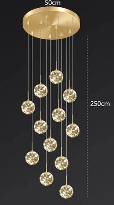 an image of a chandelier with gold balls hanging from it's ceiling