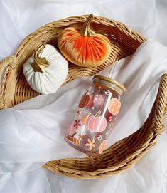 a wicker basket with pumpkins and other items on it