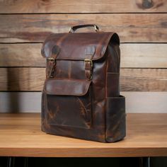 Personalized Leather Backpack, Travel Backpack Rucksack, Brown Leather Roll Top Backpack, Laptop Bag, Unisex Bag If you have any query then just message me and get response within 5 minutes. Happy Shopping.. ● * Description of the Backpack  * ● * Dimensions: 12 x 16 x 5 Inches || 30 x 40 x 13 CMs. ( L x H x W) * The Backpack is crafted out of the premium quality of Buffalo leather. *  Polyester lining * The Backpack contains 2 spacious compartments for books, files and a laptop. One of the compa Vintage Satchel Backpack For On-the-go, Vintage Brown Backpack For On-the-go, Large Capacity Backpack Laptop Bag For Trips, Large Capacity Laptop Backpack For Trips, School Backpack With Luggage Sleeve, Vintage Backpack For On-the-go, Vintage Style On-the-go Backpack, Daily Use Backpack Satchel With Luggage Sleeve, Vintage Large Capacity Backpack For Everyday