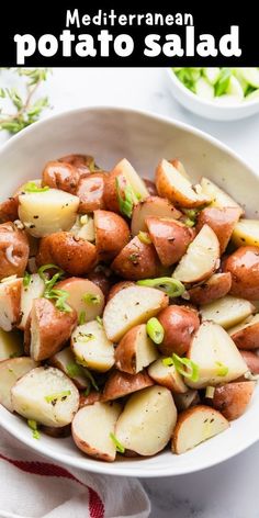 a white bowl filled with potatoes and garnished with parsley on the side