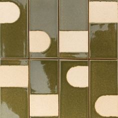 several square tiles with white and green designs on them