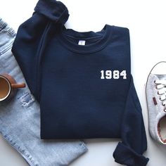 🎉 Celebrating a Milestone in Style - The Ultimate 40th Birthday Sweatshirt 🎉 Are you on the hunt for the perfect gift to celebrate a fabulous 40 years? Look no further! Our handcrafted 1984 Sweatshirt is the epitome of comfort meets celebration. Made with love and care, this cozy sweatshirt is not just a piece of clothing; it's a wearable hug that commemorates a special milestone. Ideal for those born in 1984, this 40th Birthday Gift Shirt is a unique and thoughtful present that will be cheris 40th Birthday Ideas For Women Outfits, Best 40th Birthday Gifts For Women, 40th Birthday Presents For Women, 40th Birthday Outfits For Women, 40th Birthday Gifts For Women, Birthday Outfit For Women, Birthday Sweatshirt, Spring Clothing, Birthday Gift For Women