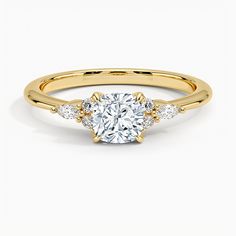 a yellow gold engagement ring with three diamonds