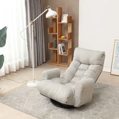 a living room with a recliner chair and book shelf