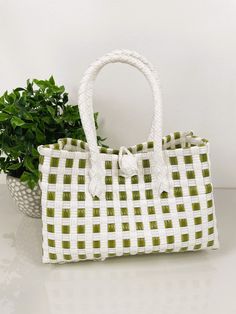 "SAGE GREEN TOTE HANDBAG  9.5\"x4.5\" WIDE Very durable and fashionable hand-woven market-style checkered handbag. We have many different colors available. This bag is made of premium plastic and embellished with beautiful beaded handles.  Let us help you replicate that special beach island getaway feels with imported Balinese products at wholesale prices. We are your source for crisp and clean bohemian coastal decor to echo that pure and organic lifestyle you've been looking for. We'll provide Green Handheld Bucket Bag With Large Capacity, Green Handheld Bags With Large Capacity, Trendy Green Satchel For Travel, Large Capacity Green Handheld Bags, Green Pouch Bag For Daily Use, Green Satchel Bag For Shopping, Trendy Green Large Capacity Bag, Trendy Large Capacity Green Bag, Trendy Green Rectangular Shoulder Bag