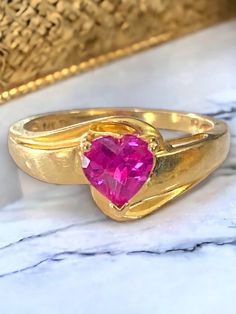 "Beautiful Estate 14k Yellow Gold MOM Pink Spinel Heart Ring Size 7 Very pretty ring crafted of solid 14k Yellow Gold! * The beautiful solid 14k gold band has \"MOM\" cutout on both top and bottom of ring! * Incredibly BEAUTIFUL heart shaped bright pink heart center stone! * Weighs 3.8 grams total. * Size 7 Shipped FAST AND FREE, with insurance in a gift box! I guarantee item to be as described and pictured - please shop with confidence :)" Valentine's Day 14k Gold Ruby Ring, Heart-shaped 14k Gold Birthstone Ring, 14k Gold Heart-shaped Ruby Ring For Promise, 14k Gold Heart-shaped Ruby Promise Ring, Gold Ruby Ring For Valentine's Day, Valentine's Day Gold Ruby Ring, Heart-shaped Yellow Gold Ruby Ring, Yellow Gold Heart-shaped Ruby Ring, Heart-shaped Yellow Gold Birthstone Ring