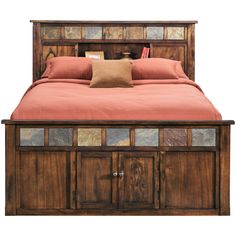 the bed is made with wood and has red sheets on it, along with pillows