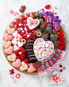 valentine's day dessert platter with heart shaped candies, chocolates and marshmallows