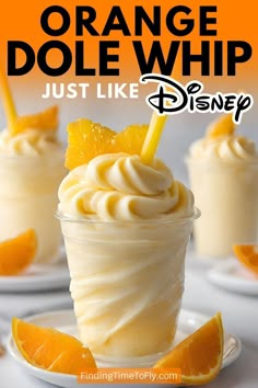 orange dole whip in a glass with an orange slice on top and the words, just like disney