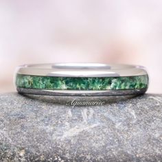 Green Moss Agate Men's or Women's Wedding Band - a testament to the timeless union of natural elegance and modern craftsmanship. This exquisite piece of jewelry seamlessly blends the rugged beauty of nature with the durability of contemporary materials, making it the perfect symbol of your enduring love and commitment.►Crafted with precision and passion, this wedding band features a striking 8mm wide band made from lustrous silver tungsten. Tungsten is renowned for its strength and resilience, e Silver And Green Wedding, Green Wedding Band, Contemporary Materials, Agate Wedding, Green Moss Agate, Tungsten Ring, Womens Wedding Bands, Fine Jewelry Collection, Wide Bands