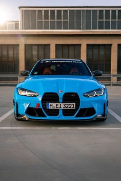 a blue car parked in front of a building