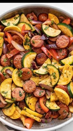 a pan filled with sausage and vegetables