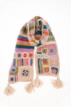 a multicolored knitted scarf with tassels