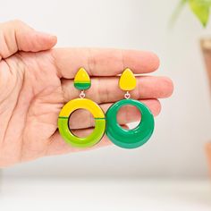 Add style and elegance to your outfitsw with these Green Mismatched Geometric Earrings!  The autumn-inspired colors make them a perfect accessory for the season. They make a thoughtful gift for Mom or Sister on their birthday, or treat yourself to a pair and turn heads wherever you go! Handmade with wooden elements and finished with epoxy resin the earrings come in three type of suspension: clip-on, silver, or silicone studs. More geometric earrings: https://www.etsy.com/shop/JewelryKatMade?sect Modern Yellow Earrings For Party, Modern Yellow Single Earring, Retro Green Earrings For Party, Green Retro Party Earrings, Modern Yellow Dangle Earrings, Retro Hypoallergenic Earrings For Gift, Retro Dangle Clip-on Earrings For Gift, Retro Yellow Dangle Earrings, Modern Green Earrings As Gift