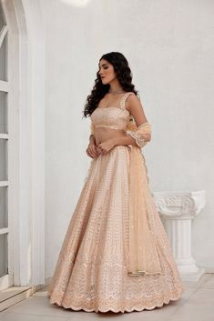 Dusty peach mirror and leather applique skirt on dupion silk paired with embroidered top and tulle dupatta.From Chamee and Palak's The Romantics collection.DELIVERY TIMEPlease allow 8-12 weeks for your outfit to arrive.FABRIC DETAILSSilk, NetProfessional cleaning only. Elegant Peach Lehenga With Dupatta, Festive Peach Georgette Lehenga, Peach Reception Dress With Sheer Dupatta, Designer Peach Lehenga With Mirror Work, Party Wear Dresses With Mirror Work In Tissue Silk, Peach Dupatta With Mirror Work For Reception, Embroidered Peach Dress For Party, Peach Dress For Festive Reception, Festive Peach Dress For Reception