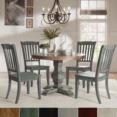 a dining room table with four chairs and a chandelier