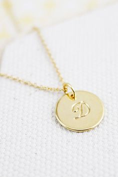 "** A B K M D L R Initial Necklace ** Available in gold MATERIALS Gold plated SIZE ♥ Circle charm : 1/2 '' diameter ♥ Chain length : 17 '' ( as pictured ) **If you want to send a message for your gift , Please leave us note at \" Send note to seller . SHIPPING TIME Fast shipping within 1 - 3 days CAUTION - We do not recommend to buy it if you have allergic and sensitive skin - Do not wear it taking shower ,to the pool, spa, or the beach - Remove when you sleeping, exercising, - Avoid contact wit Circle Necklace With Initial, Personalized Gold Plated Charm Necklaces, Personalized Gold-plated Charm Necklaces, Personalized Round Gold Plated Charm Necklaces, Round 14k Gold-tone Charm Necklaces, Round Gold-tone 14k Gold Charm Necklace, Round 14k Gold-tone Charm Necklace, Gold Round Charm Necklace Tarnish Resistant, Gold Round Charm Necklace, Tarnish Resistant