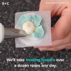 a person is holding a small flower on top of a piece of paper with the words we'll take frosting flowers over a dozen roses any day