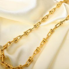 Featuring unique U-shaped links in 18k gold plating, this U Link Chain Necklace is a modern take on classic chain styles. Its contemporary design adds a chic edge to any ensemble. Modern Gold Plated Paperclip Chain Necklace, Modern Gold-plated Paperclip Chain Necklace, Modern Gold Plated Link Chain Necklace, Luxury Gold Plated Chain Necklace With Solid Link, Luxury Gold-plated Chain Necklace With Solid Link, Modern Gold Cable Chain Necklace, Luxury Gold Chain Link Necklace, Elegant Chunky Chain Necklace With Rectangular Links, Elegant Gold Chain Necklace With Solid Link