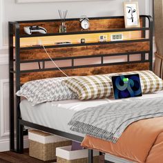 a bed with a wooden headboard and metal frame