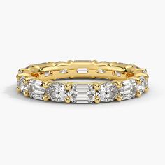 a gold and white diamond ring with three rows of diamonds on the side, set in 18k yellow gold