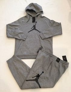 This listing is for a New Men’s Nike Air Jordan Sweatsuit Set (Hoodie and Sweatpants) Hoodie - Soft fleece hoodie - Adjustable hood with drawstrings - Kangaroo pockets - Ribbed cuffs and hem Sweatpants - Soft fleece sweatpants - Adjustable waistband with drawstrings - Two side pockets - Cuffed leg openings Size: Men’s Size X-Large Condition: New with tags.100% Authentic..Never worn Color: Grey with With Black Logo Thanks for looking Items are shipped the same day or the next business day Jordan Fleece, Grey Sweatsuit, Air Jordan Outfit, Nike Clothes Mens, Sweatpants And Hoodie, Stylish Mens Suits, Cute Nike Outfits, Hoodie Pants, Jordan Outfits