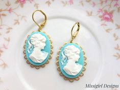 These beautiful Cameo earrings were created with 18x25mm brass scalloped settings adorned with 18x25mm Aqua blue cameo cabochons and brass lever back ear wires. These gorgeous earrings hang beautifully from lever back ear wires and measure 1 3/4 inches in length and 3/4 inches in width. These earrings are very romantic and chic...You will truly enjoy these for many years to come. *All of my listings are handmade with love and ready to ship and will arrive to you in a gift box with bow for easy g Blue Cameo Jewelry For Wedding, Turquoise Dangle Clip-on Earrings For Gift, Turquoise Dangle Clip-on Earrings As Gift, Turquoise Clip-on Jewelry For Gift, Turquoise Clip-on Jewelry Gift, Turquoise Clip-on Earrings As Gift, Victorian Earrings, Cameo Earrings, Jewelry Turquoise