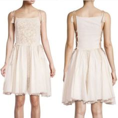 This Is A Gorgeous Feminine Dress With Lace Up Open Sides, Beautiful Embroidery, And Lace Trim. It Has Both Shoulder And Side Ties That Can Be Adjusted For Fit. Squareneck Sleeveless Shoulder And Side Ties Lace Trims Raw Edge Hem Measurements: Bust: 33.5"-34" Natural Waist: 25"-26" Low Waist: 25"-26" Hips: 36" This Comes From A Pet And Smoke Free Home. Please Let Me Know If You Have Any Questions! Spring A-line Dress With Cutwork Hem, Spring Sleeveless Dress With Embroidered Hem, Feminine Dress With Embroidered Hem For Spring, Feminine Mini Dress With Cutwork Hem, Feminine Spring Dress With Embroidered Hem, Chic Embroidered Cotton Mini Dress, Chic Cotton Dress With Floral Embroidery, Elegant Embroidered Cotton Mini Dress, Chic Beige Embroidered Dress