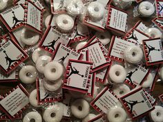 many white donuts with black and red labels on them are in plastic wrappers