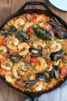 a skillet filled with seafood and rice