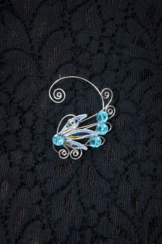 a brooch with some blue beads on it