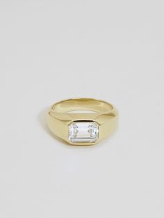 Signet rings were historically used as identity markers, wearable tools for sealing official documents. Ours incorporates an elegant detail — set flush with an emerald cut diamond in the size of your choice. The Sienna Emerald Cut band measures approximately 7mm wide in the front, tapering to 3.5mm in the back. Our classic Sienna Emerald can be purchased here, simply let us know your ring size in the order notes at checkout.Our standard clarity and color for 0.50ct and 0.75ct diamond sizes is VS Emerald Cut Band, Signet Engagement Rings, Classy Engagement Ring, J Hannah, Diamond Signet Ring, Future Engagement Rings, Signet Rings, Diamond Jewelry Designs, Emerald Cut Diamond