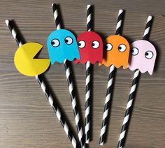 four paper paco straws with black and white striped sticks in front of them