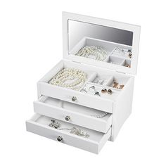 an open jewelry box with three drawers and two necklaces on the bottom, one is white