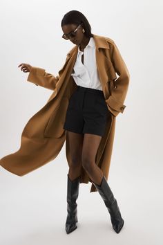 Step out in style with the Margaret Wool Trench. With its buttoned single layer and open lapel, this jacket exudes a sophisticated charm that is both refined and feminine. Envelop yourself in the soft wool, and cinch your waist with the self tie belt. Whether heading to the office or out to dinner, this trench adds an elegant flair to every look. Chic Wool Coat With Belted Cuffs And Lapel Collar, Timeless Outerwear With Belted Cuffs For Work, Elegant Brown Collared Blazer, Camel Long Coat For Work, Camel Long Coat For Workwear, Chic Wool Coat With Pockets, Chic Camel Wool Coat For Work, Camel Lapel Collar Outerwear For Work, Chic Wool Coat With Lapel Collar And Pockets