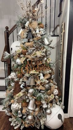 a christmas tree decorated with silver and white ornaments