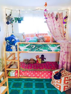 a bunk bed with curtains and lights in a room that is decorated like a child's bedroom