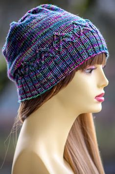 a mannequin head wearing a knitted hat