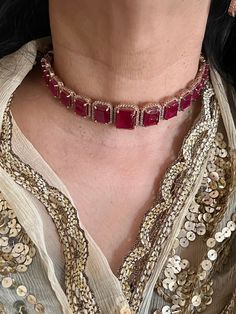 A symbol of feminism and elegance. Prepare yourself for the festive season with this Ruby CZ Choker Set with Earrings. Be it a gift, cocktail night or wedding reception this piece will add charm to your personality. Product Details: Material: Each piece is meticulously handcrafted from high-quality brass, CZ Stones. Necklace Dimensions: Weight: 45 grams. Closure Type: Premium Dori Adjustable Size: Yes  Earring Dimensions (Per Pair): Weight: 18 grams Length: 4 cm Width: 1.8 cm Closure Type: Push Red Diamond Earrings For Party, Fine Jewelry Plated, Red Diamond Party Earrings, Glamorous Gold Plated Earrings For Parties, Elegant Earrings For Valentine's Day Party, Elegant Party Earrings For Valentine's Day, Diamond Round Jewelry For Parties, Silver Gold-plated Necklace For Party, Round Diamond Jewelry For Party