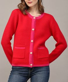 This gorgeous cardigan features a button front closure, two front pockets, long seeves and a chic color block design. A must for dressing up or down, this sweater can be styled buttoned or worn unbuttoned and layered over a blouse or top. 36% acrylic, 30% nylon, 28% pbt, 6% wool Model is wearing a size small and is 5'10" Chic Winter Cardigan With Buttoned Pockets, Color Block Cardigan For Winter, Red Color Block Winter Outerwear, Trendy Red Sweater With Buttons, Trendy Red Sweater With Button Closure, Red Sweater With Button Closure For Fall, Red Winter Sweater With Buttons, Red Buttoned Cardigan For Spring, Red Sweater With Buttons For Winter