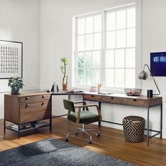 an office with a desk, chair and potted plant in the window sill