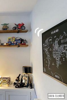 a white room with shelves filled with toy cars and other items on top of it