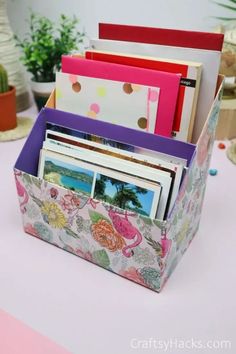 an assortment of greeting cards in a box on a table with flowers and polka dots